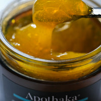 Apothaka golden nectar jelly balm cleanser close up of texture showing orange gelled oil on a spatula