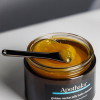 Apothaka golden nectar jelly balm cleanser texture with metal spatula for application